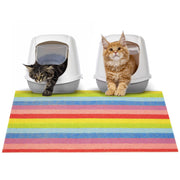 Two cats with rainbow striped litter mat and two white covered litter boxes on white background