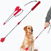 Red collapsible dog training stick with hand grip and target paddle, shown with golden retriever