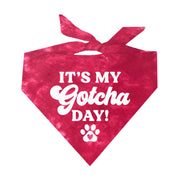 Red tie-dye dog bandana with white text reading It's My Gotcha Day and a paw print