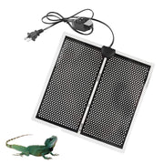 Black perforated reptile heat mat with power cord and dimmer switch next to green iguana