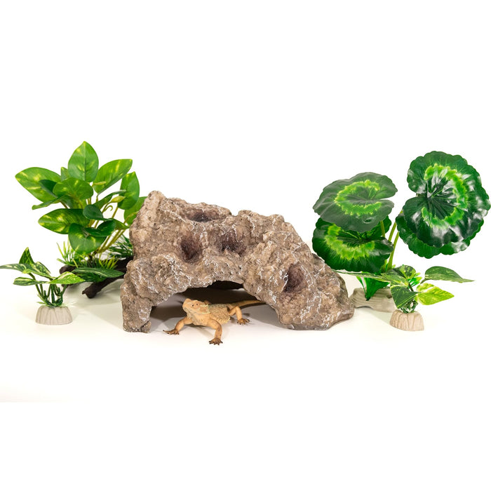 Brown textured reptile cave hideout with artificial plants and small gecko underneath on white
