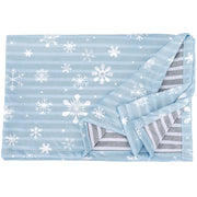 Light blue cooling dog blanket with white snowflake pattern showing reversible gray striped side