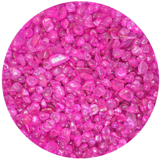 Bright pink rose aura quartz crystal chips in circular display showing tumbled stone texture