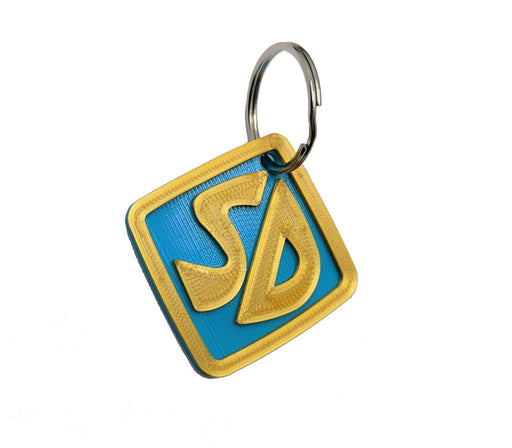 3D printed blue and gold SD Scooby-Doo keychain tag with silver split ring