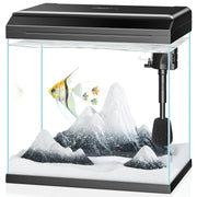 Clear 7-gallon fish tank with black hood, filter, heater, white sand and decorative rocks setup