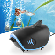 Black shark-shaped aquarium air pump with blue trim creating bubbles underwater with colorful fish