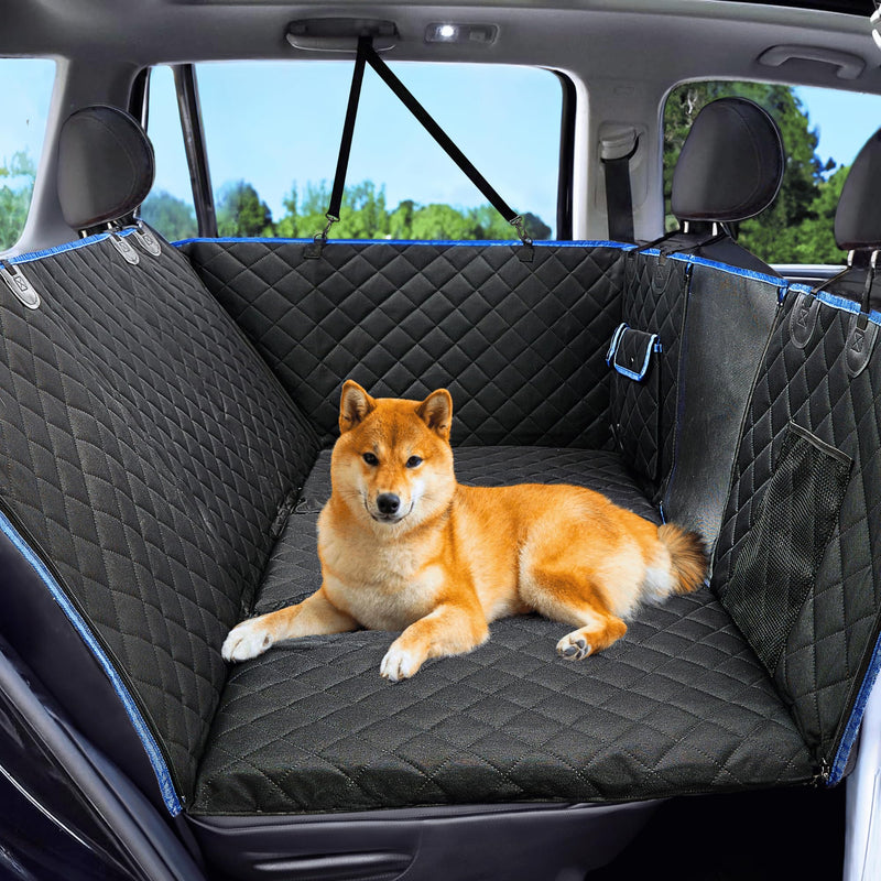 Orange Shiba Inu dog lying on black quilted waterproof car seat cover with blue trim