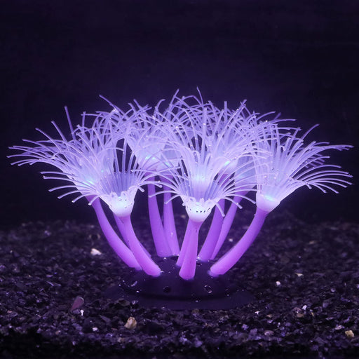 Purple silicone coral decoration glowing underwater with feathery tentacles on dark substrate