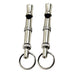 Two silver metal dog training whistles with keyrings on white background