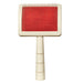 Pet slicker brush with cream handle and red bristle pad showing fine metal pins on white background