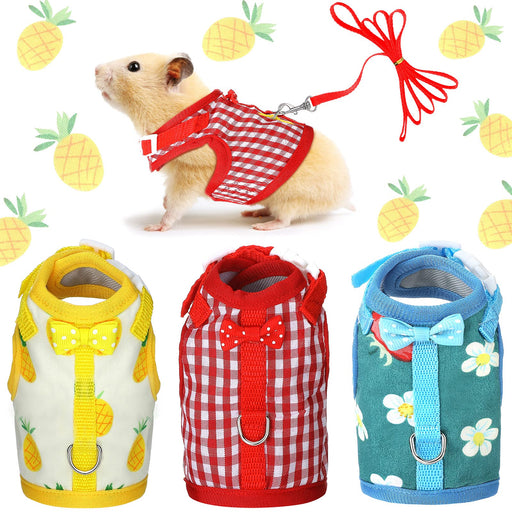 Small pet harnesses in yellow pineapple, red gingham, and blue floral patterns with matching leashes