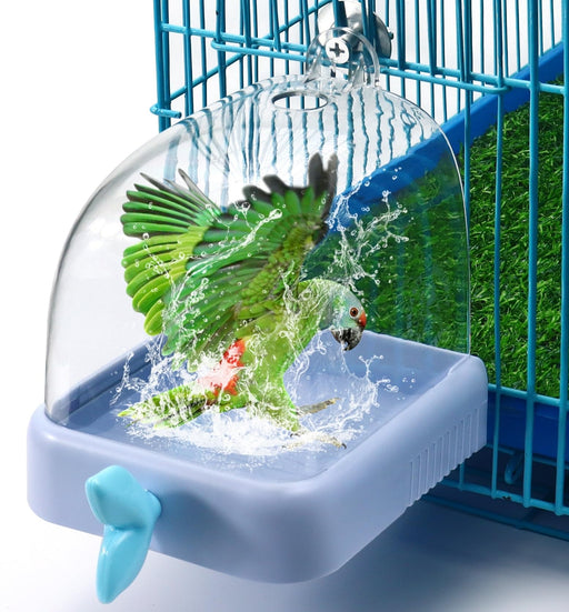 Green parrot splashing water in blue square bird bath attached to cage with shower feature