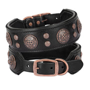 Two black leather dog collars stacked showing copper Celtic medallion studs and buckles