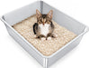Tabby kitten sitting in stainless steel litter box filled with beige wood pellet litter