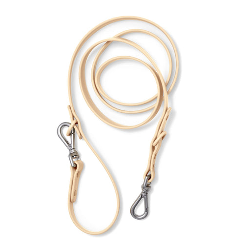 Tan biothane dog leash with two silver swivel clips laid flat on white background