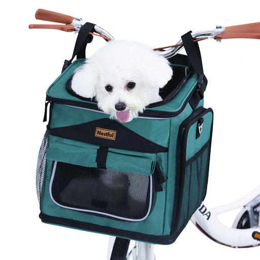 White fluffy dog sitting in teal expandable bike basket carrier with mesh windows and handlebars