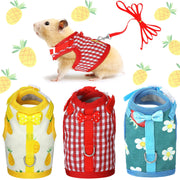 Three small pet harnesses in yellow pineapple, red gingham, and blue floral patterns displayed flat