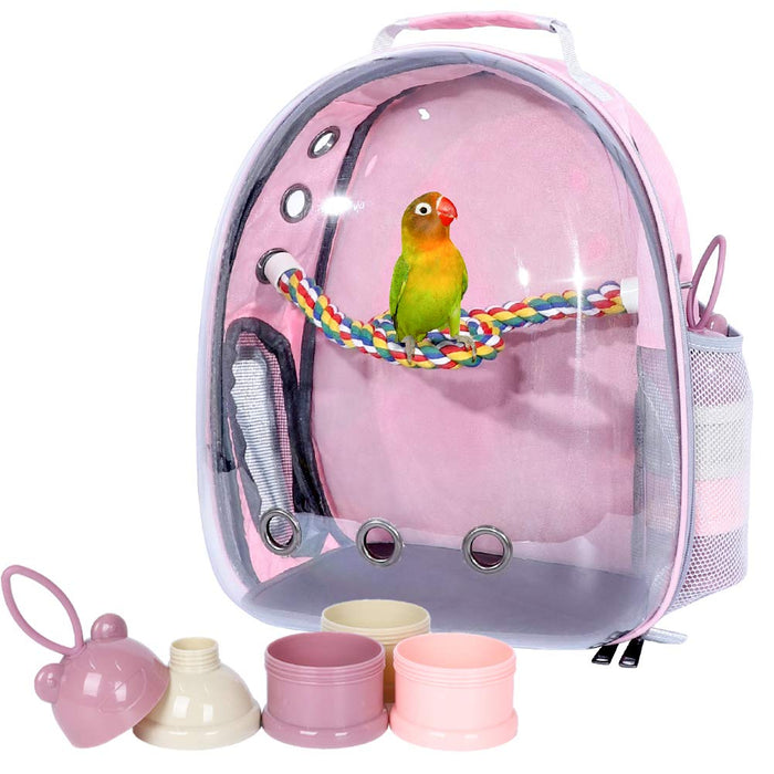 Pink transparent bird backpack carrier with lovebird perched on colorful rope, accessories displayed