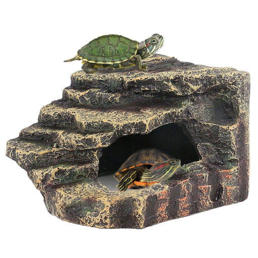 Natural rock reptile basking platform with two turtles, one on top and one inside cave opening