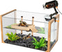 Glass turtle tank with wooden frame, basking platform, plants, and overhead heat lamp attached