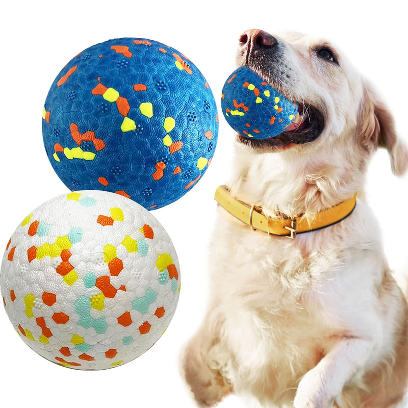 Golden retriever with blue textured ball in mouth next to two colorful dog balls on white background