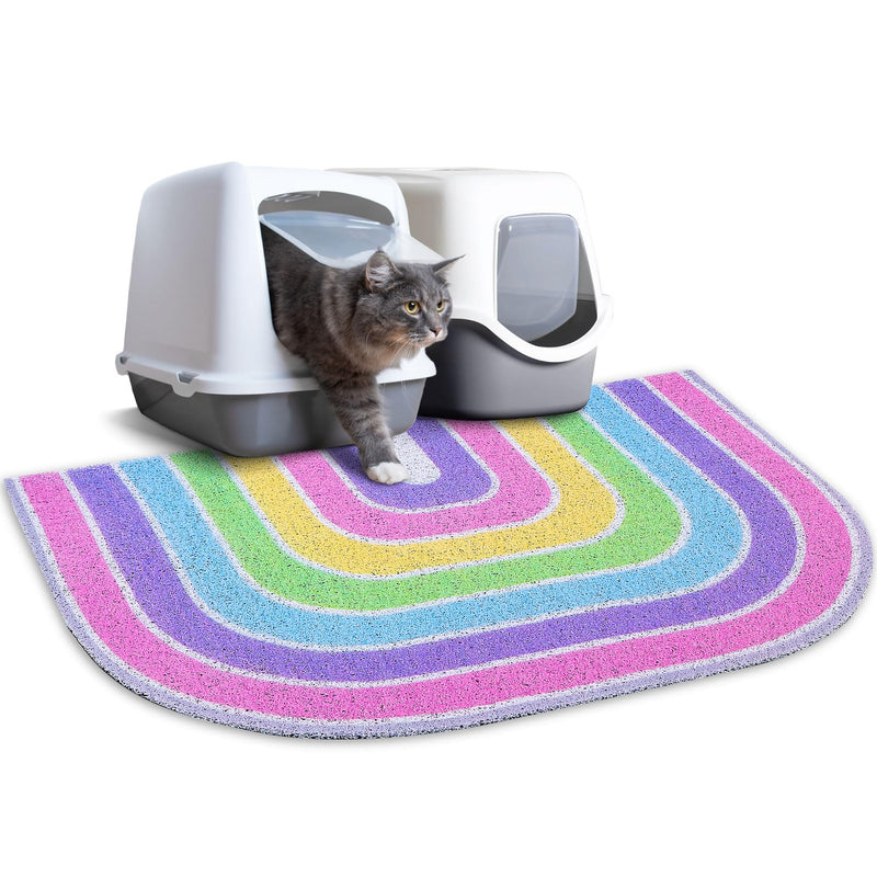 Gray tabby cat exiting white hooded litter box on colorful rainbow striped trapping mat