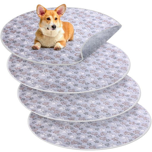 Orange corgi puppy sitting on stacked washable training pads with paw print pattern