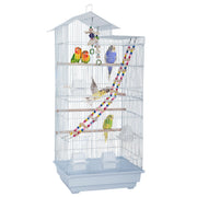 White tall bird cage with colorful parrots, perches, toys and ladder on white background