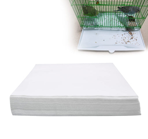 Stack of white bird cage liner papers shown from side angle displaying thickness and quantity