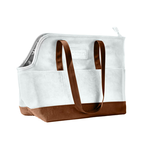 White canvas dog carrier tote with brown leather bottom and handles on white background