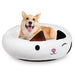 Corgi dog sitting in white cat-shaped donut pet bed with black ears and cute face design