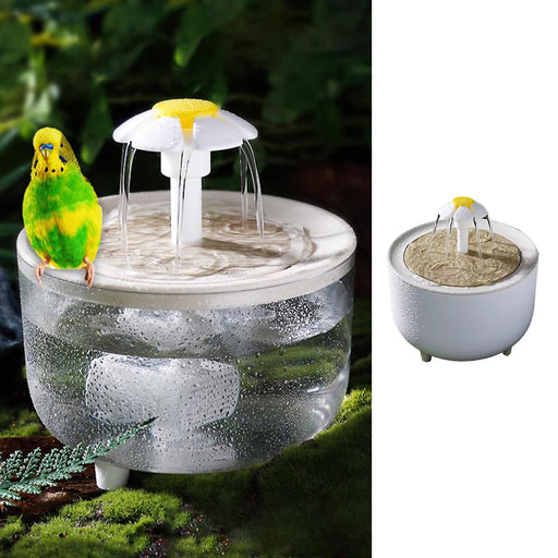 White circular bird bath fountain with yellow flower top and green budgie perched on edge