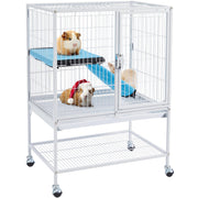 White multi-level guinea pig cage on wheels with three guinea pigs on blue platforms