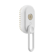 White pet grooming brush with steam nozzle, USB charging cord and bristled head on white background