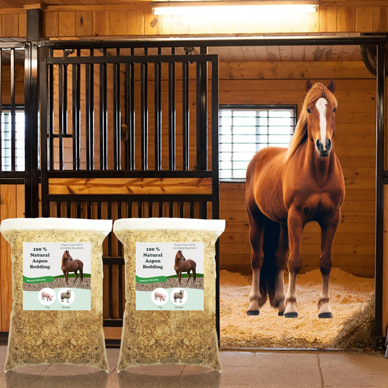Two bags of natural aspen wood shavings bedding displayed in front of a horse stable