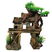 Weathered wooden house aquarium ornament with artificial green plants on white background