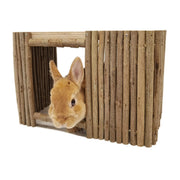 Orange rabbit peeking out from natural wood slat hideaway tunnel with vertical wooden bars